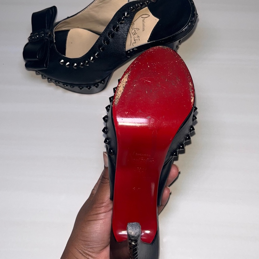 Christian Louboutin studded black leather platform pump.